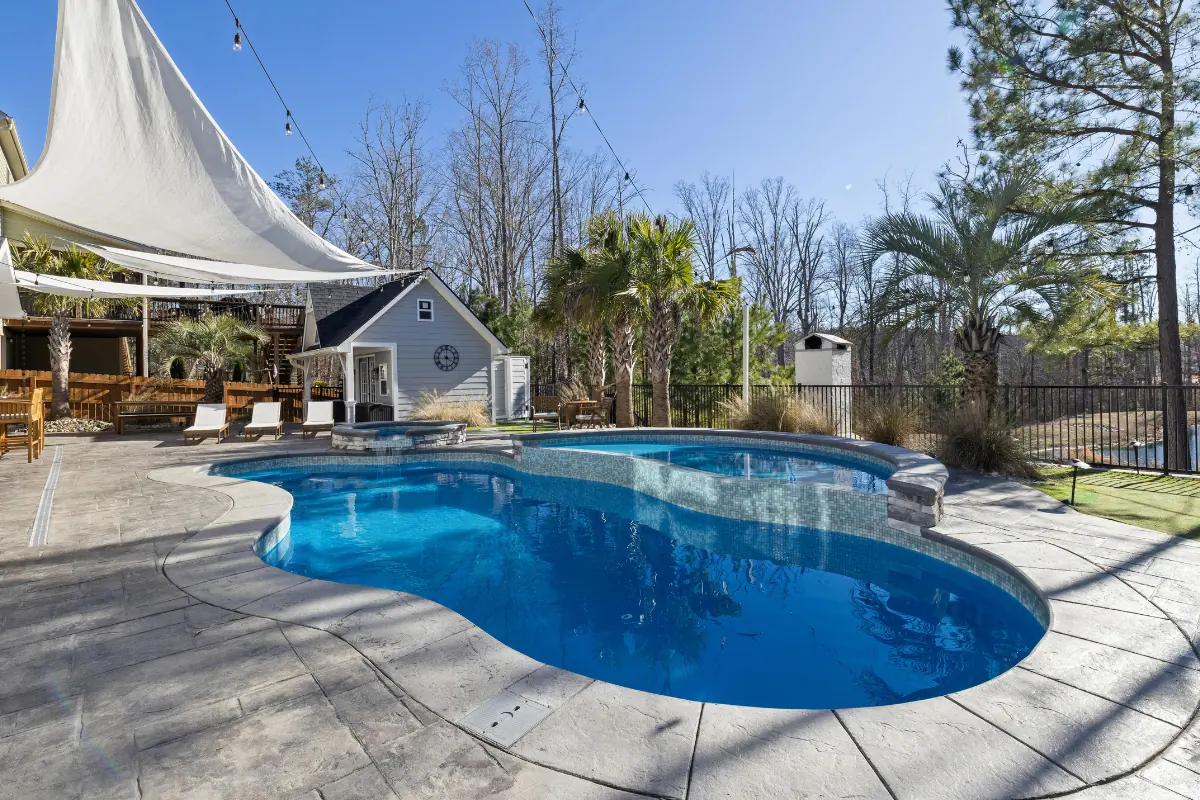 Stamped concrete pool deck around freeform pool NC Foothills — The Concord Concrete Company
